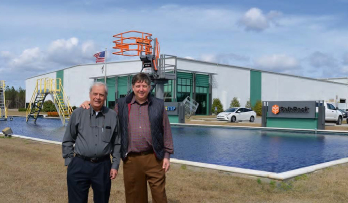 SafeRack co-founders Fred Harmon and Rob Honeycutt stand in front of the global company’s 225,000-square-foot facility in Andrews, S.C.